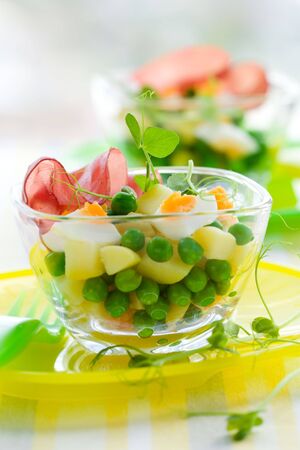 spring salad witn potato,egg, pea and hamの写真素材