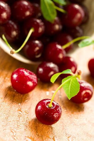 wet ripe cherries on the wood tableの写真素材