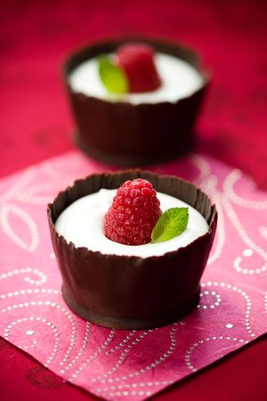 white chocolate mousse dessert served with fresh raspberry and mint in an edible chocolate cupの写真素材