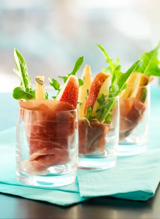 appetizer with pear,prosciutto,arugula,gorgonzola in glassesの写真素材
