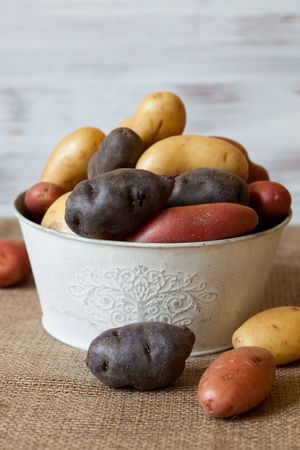 Various varieties of new,red and purple potatoesの写真素材
