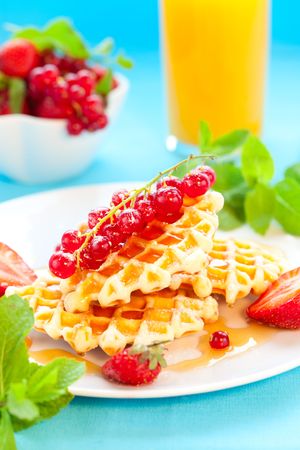 Belgian waffles with honey and berriesの写真素材