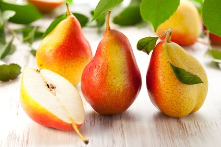 fresh pears with leaves  on the white wooden  tableの写真素材