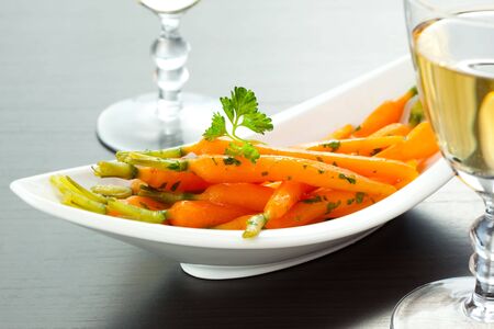 Glazed baby carrots with parsley and white wineの写真素材