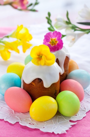 Easter cake with glace icing and coloured easter eggsの写真素材