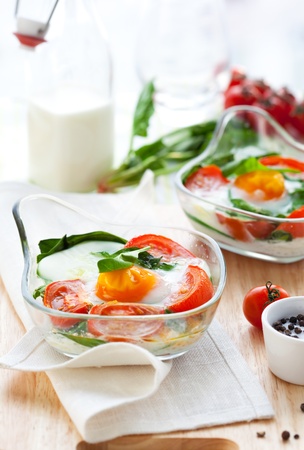 Baked egg with tomatoes,spinach and toastの写真素材