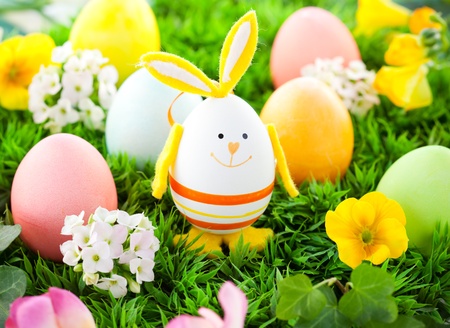 colorful Easter Eggs and rabbit on the grass