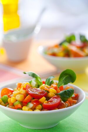 fesh vegetable salad with corn,carrot,tomato,cucumber and sweet pepperの写真素材
