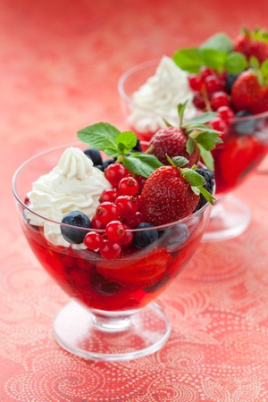 Berry dessert  with cream and fresh fruits in glassesの写真素材
