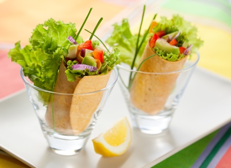 fresh  tortilla wraps with vegetables in glassesの写真素材