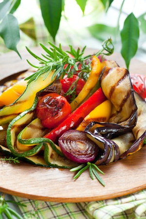 Grilled vegetables with rosemary and thyme on the wooden plateの写真素材