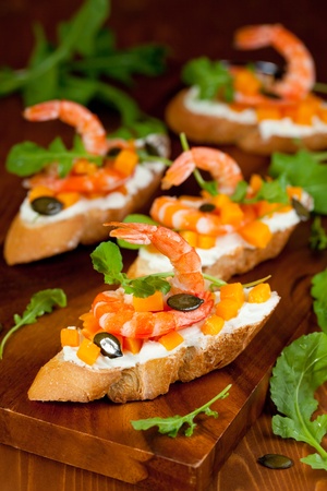 Shrimp and pumpkin toast with soft cheese, arugula and pumpkin seedsの写真素材