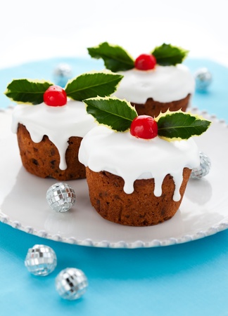 Christmas mini  cakes with holly leaves and berriesの写真素材