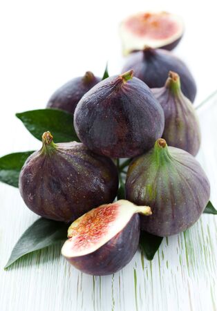 Several whole figs and one halved figの写真素材