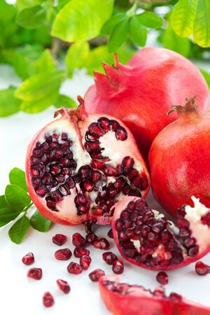 Pomegranates, whole and cut openの写真素材
