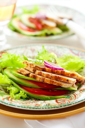 Chicken salad with avocado and tomatoesの写真素材