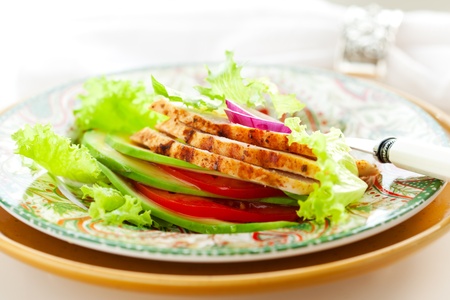 Chicken salad with avocado and tomatoesの写真素材