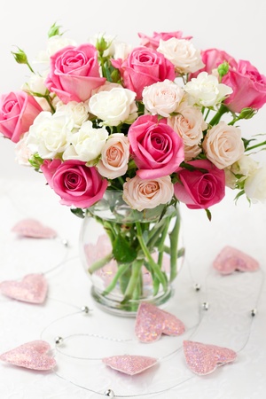 festive bouquet of pink and white roses in vaseの写真素材