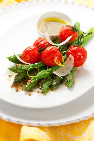 green asparagus with roasted tomatoes,cheese and lemon mustard dressingの写真素材