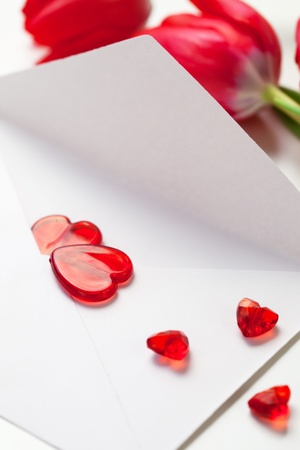 Red hearts on a letter and tulips for Valentines Dayの写真素材
