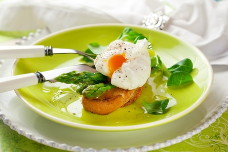 Poached egg and green asparagus on toastの写真素材
