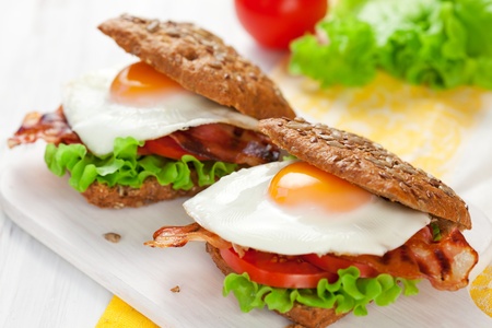 fried egg,tomato and bacon in wholemeal sandwichの写真素材