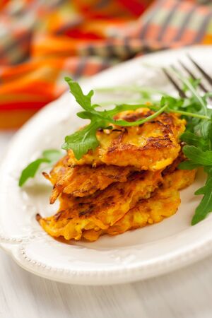 Carrot pancakes with rucola and  yoghurtの写真素材