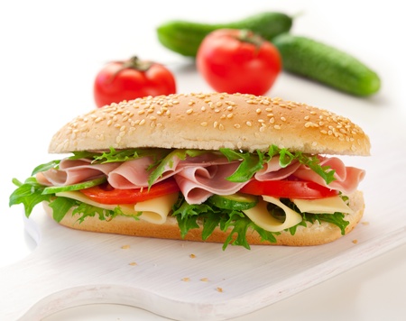 sandwich with ham,cheese and vegetables on white backgroundの写真素材