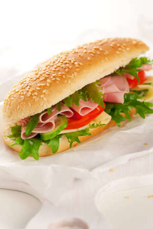 sandwich with ham,cheese and vegetables on white backgroundの写真素材