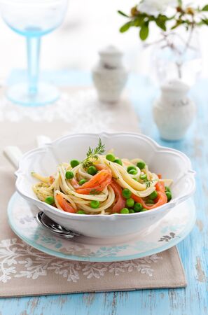 Spaghetti with salmon and green peaの写真素材