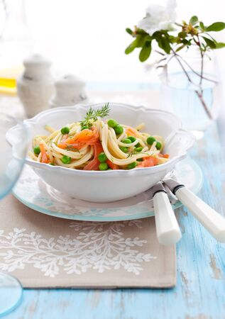 Spaghetti with salmon and green peaの写真素材