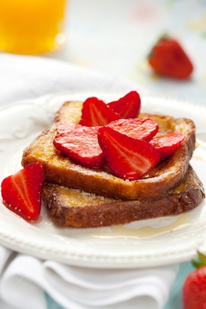 French toast with strawberries, maple syrup and  sugarの写真素材