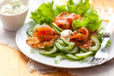 Potato rosti with smoked salmon and cucumber saladの写真素材