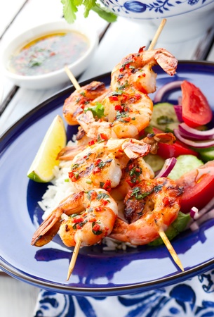 Prawn skewers with rice and vegetable saladの写真素材