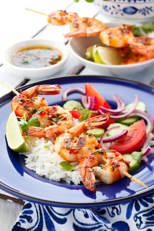 Prawn skewers with rice and vegetable saladの写真素材