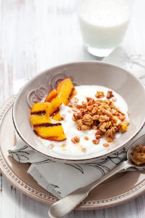 Breakfast with muesli,yogurt and grilled peachesの写真素材