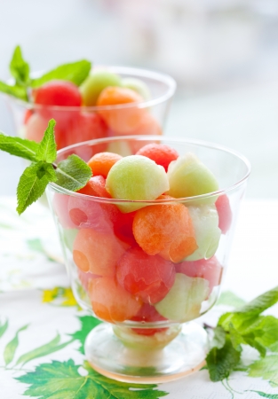 Fruit salad with melon and watermelon balls in glass bowlの写真素材