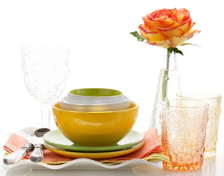 Arrangement of three colorful bowls, plates ,glasses and roseの写真素材