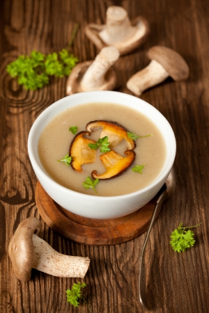 Bowl of cream of mushroom soup with fried mushroomsの写真素材