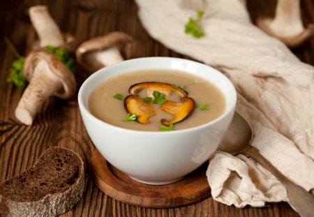 Bowl of cream of mushroom soup with fried mushroomsの写真素材