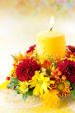 autumn wreath with yellow candle and flowersの写真素材
