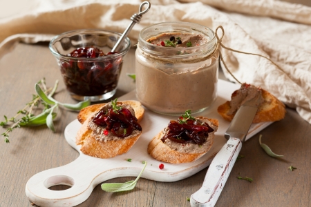 Chicken liver pate with onion jam on bread and in jarの写真素材