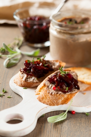 Chicken liver pate with onion jam on bread and in jarの写真素材