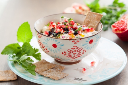 Cheese dip with pomegranate seeds and herbsの写真素材