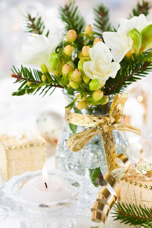 Christmas table decoration with flowers,gifts and baublesの写真素材