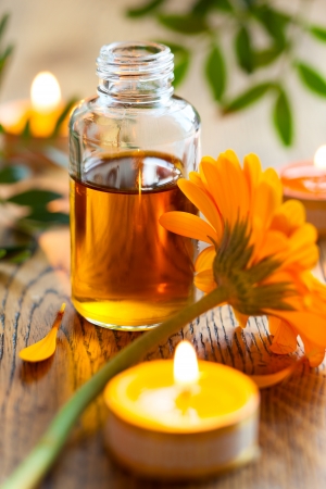 bottles of essential oil,candles and flowersの写真素材