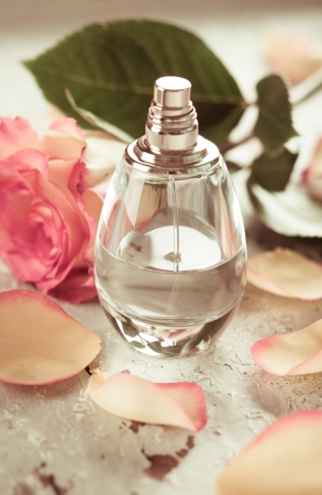 perfume bottle and rose on the old desk  in vintage styleの写真素材