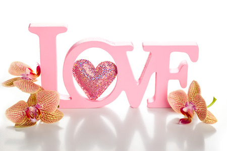 Word love with orchid on the white backgroundの写真素材