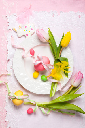 Easter table setting with tulips and easter eggsの写真素材