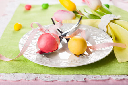 Easter table setting with tulips and easter eggs
